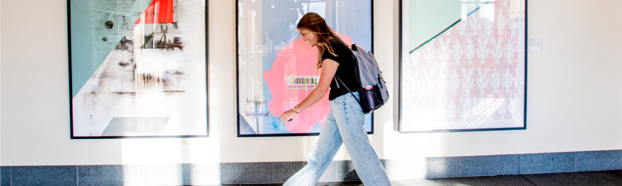 Student walking down the hall at Seidman College of Business